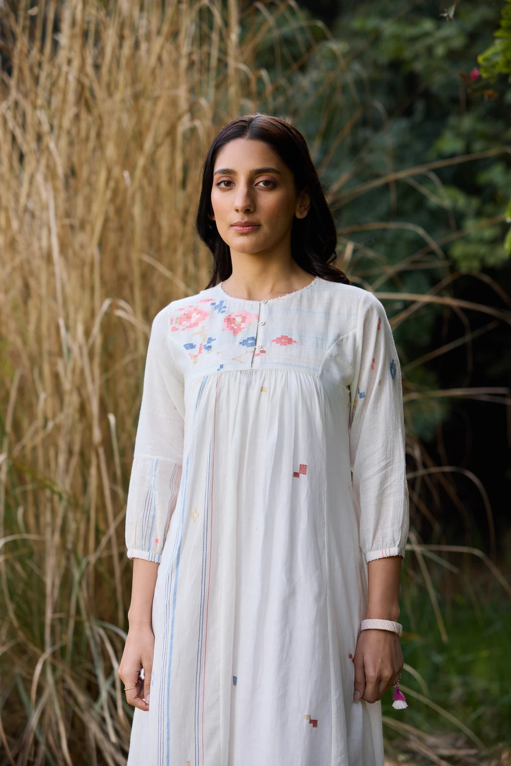 Soma Dress — White handloom cotton Jamdani dress with floral yoke — close-up | Sarron